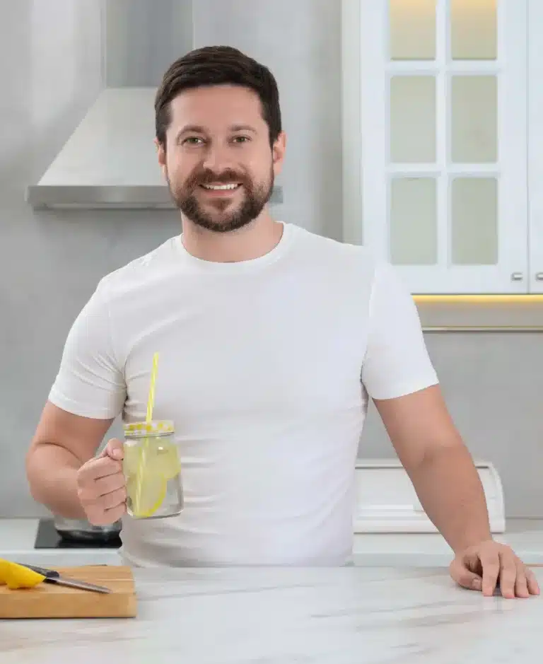 Jordan Bell, founder of EasyDetoxRecipes.com, smiling in a home kitchen