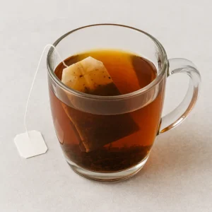 Black tea steeping in a clear mug for iced tea base