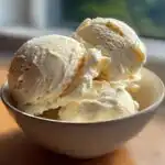 A bowl filled with three scoops of creamy Easy No Machine Vanilla Ice Cream.