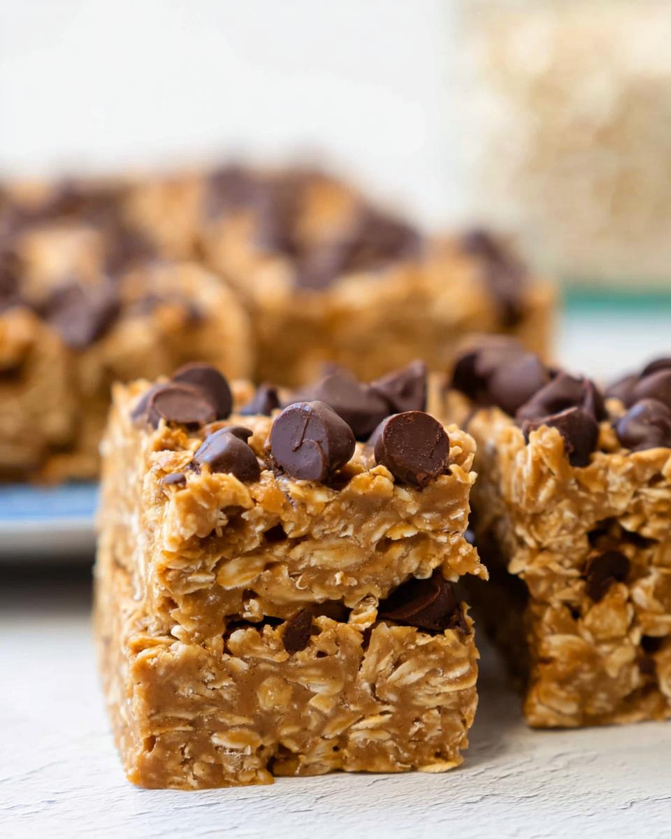 Close-up of no bake peanut butter oatmeal bars topped with chocolate chips.