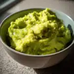 A close-up of a bowl filled with creamy 3-Ingredient Guacamole, ready to be served.