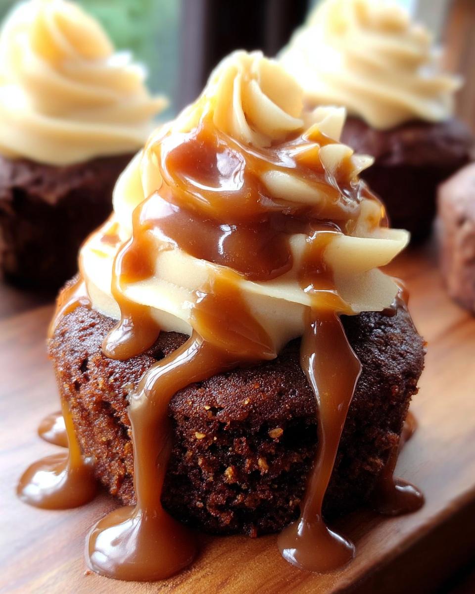 Close-up of a decadent Sticky Toffee Cupcake topped with smooth buttercream and a generous caramel sauce drizzle.